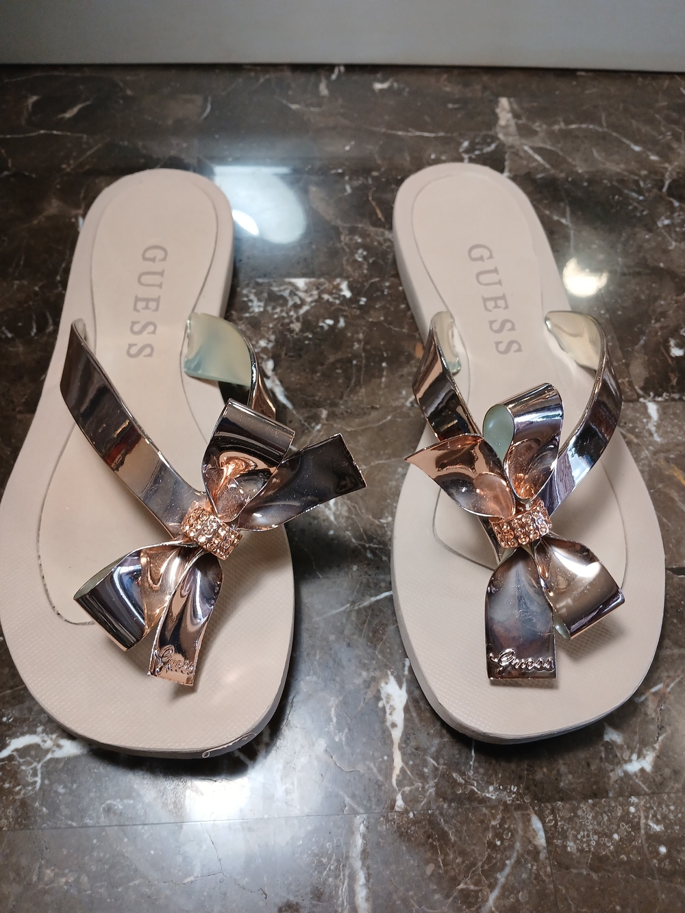 GUESS Women's Beige Sandal Flip Flops with Rose Gold Bow Accent